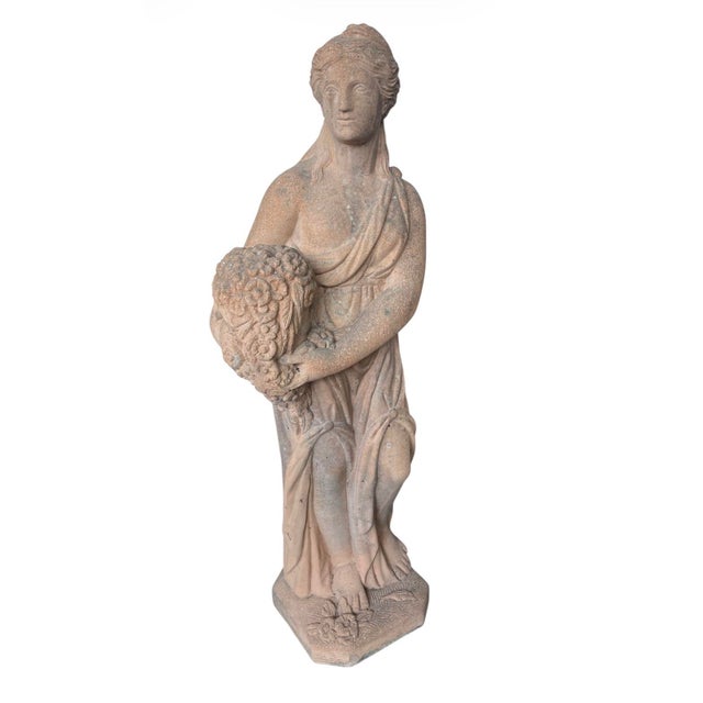 This striking vintage garden statue, rendered in warm, weathered terracotta, depicts a classical female figure likely...