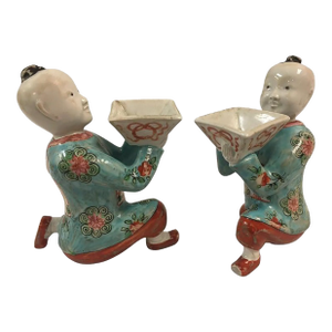 Pair of Porcelain Kneeling Chinese Boys Holding Shallow Single Blossom Vessels