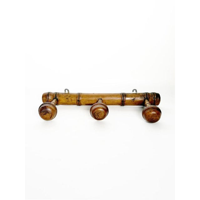 Decorative French wooden wall-mounted coat rack dating from the 1940s, characterized by a simple rustic construction and a...