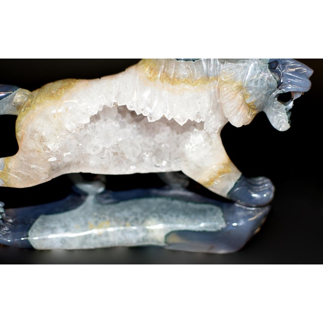 A hand-carved agate tiger sculpture, masterfully formed from a single piece of natural stone featuring a captivating open...