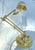 Elegant adjustable lamp crafted in polished brass, featuring a clean modernist silhouette. The design combines a weighted...
