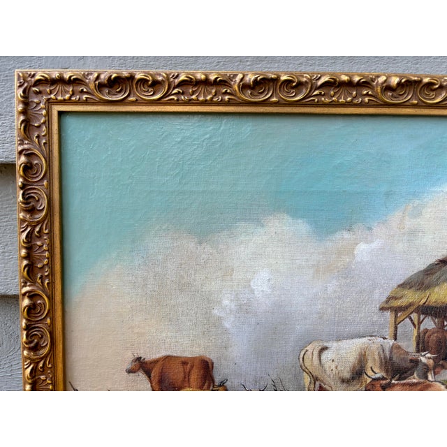 This bucolic 19th century countryside oil painting is set in a carved gilt frame and depicts a pastoral scene with resting...