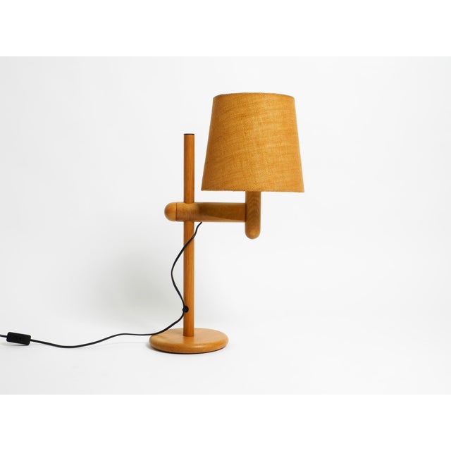 Beautiful original 1960s table lamp made of oak. the original shade is steplessly height-adjustable. the manufacturer is...