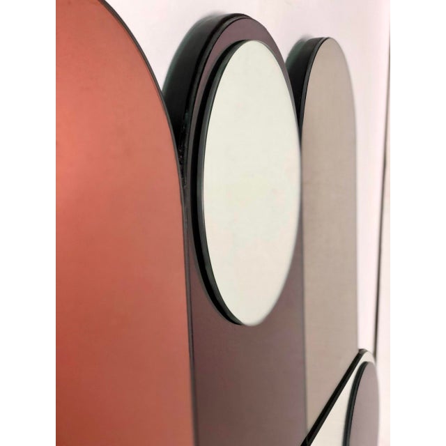 Large panoramic mirror with multiple geometric shapes in smoked colored glass in warm tones, dating from 1994 and...