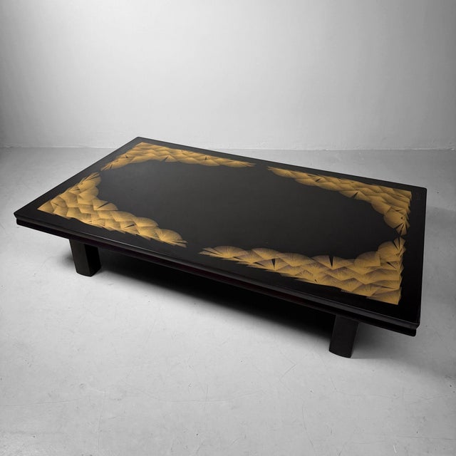 This elegant Japanese low table combines deep black lacquer with exceptionally refined chinkin decoration (沈金): finely...