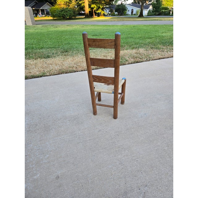 A wonderful example of early-to-mid 20th-century primitive folk art craftsmanship. This children's ladder-back chair...