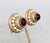 1950s round goldtone prong set cabochon faux-garnet center surrounded by faux-pearls clip back earrings. Marked "NAPIER...
