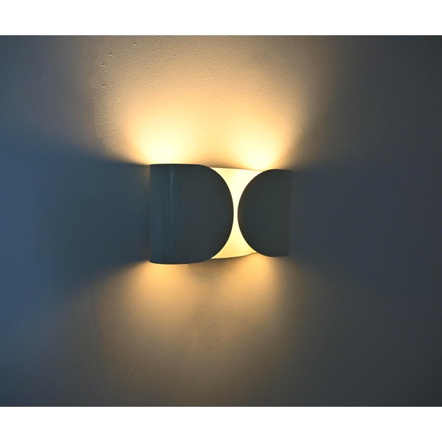 White metal wall sconce by Afra & Tobia Scarpa. Model: Foglio. Stamped Flos. Wear consistent with age and time. This piece...
