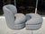 Art Deco/Postmodern style chair and a matching crescent-shaped ottoman. This specific set is highly characteristic of...