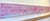 A striking two-panel diptych stretching 96 inches wide, its surface built in Koury's interference paint so the soft pink...