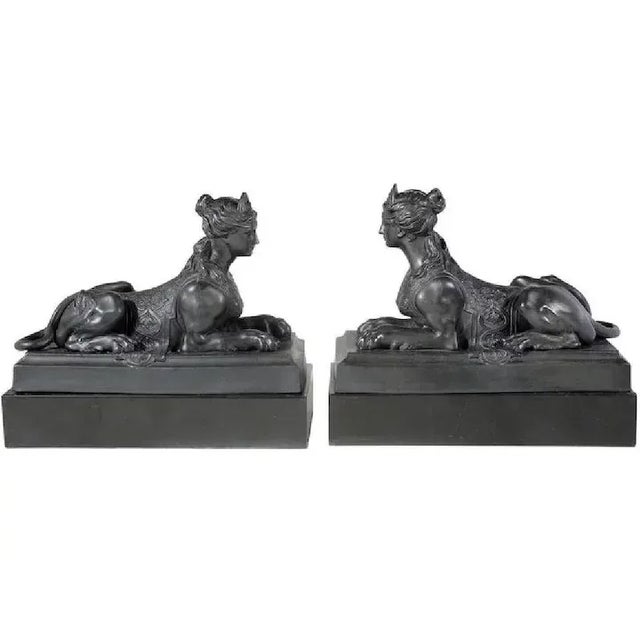 Large pair antique early 19th c. Wedgwood black basalt sphinxes. Each sphinx crouches on a rectangular pedestal with its...