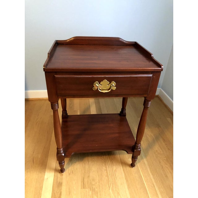 The Allen Night Stand has a rectangular top uniquely framed on back and sides with shaped wood gallery. Hand-turned posts...