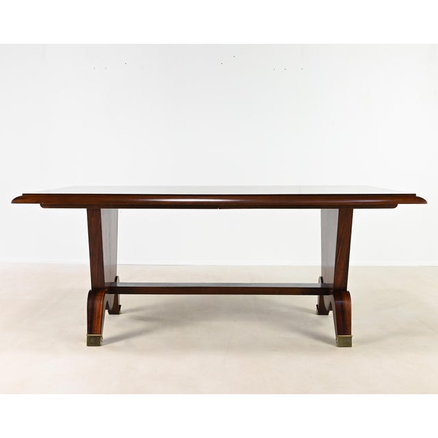 Superb Art Deco dining table in rosewood veneer and marquetry, with brass feet. Signs of wear; very good overall...