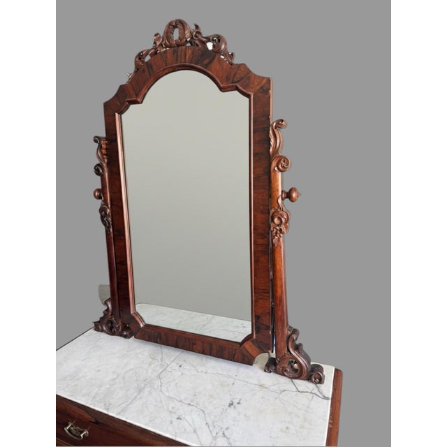 Antique Victorian Rosewood Marble Top Ladies Dresser With Mirror and nicely detailed carving. It also has a hidden drawer...