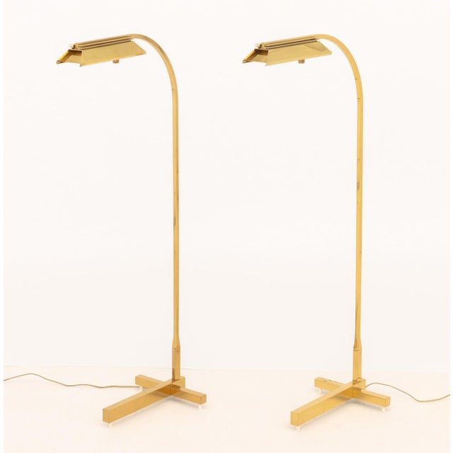 Pair of Casella Lighting Polished Brass Adjustable Floor Lamps, labels to undersides. 43" H x 18" W x 10" D. Provenance:...