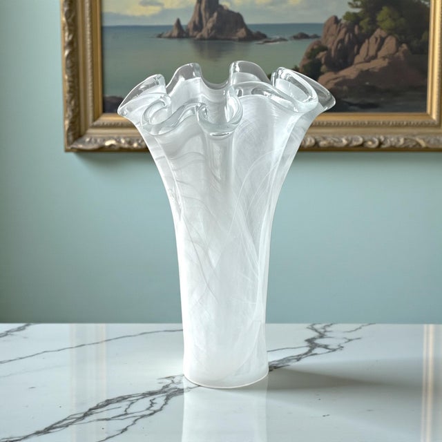 A sculptural Murano-style art glass vase featuring dramatic hand-formed ruffles and delicate internal white latticino...