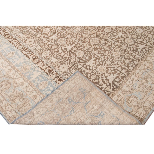 Beautiful antique Malayer hand-knotted wool rug with a brown field. This Malayer piece has a beige frame and blue accents...