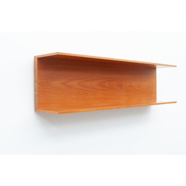 Cherry wood wall shelf for wall mounting with two hooks. Clean, functional design from the 1960s. Walter Wirz designed...