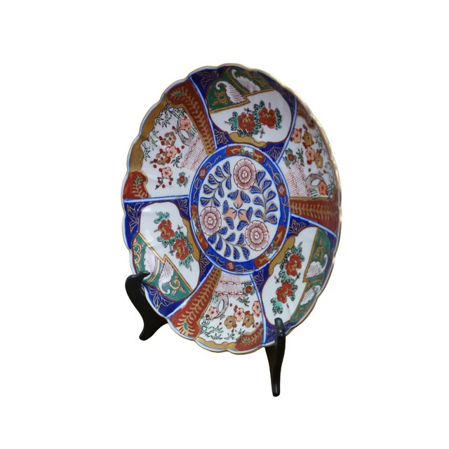 Antique Japanese scalloped floral porcelain Imari plate featuring vibrant blue red and gold accents. Dimensions: 9.5" x...
