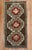 A matching pair of mid-20th century Turkish Anatolian rugs a tribal motif in red and white on a chocolate brown field...