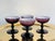 A set of four coupe champagne glasses made in Italy from a deep purple glass lined with a thin layer of white glass on a...