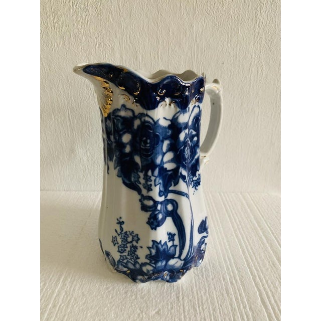 Beautiful, flow blue antique pitcher/jug, by Doulton Burslem, circa 1890's. Piece has been designed between 1862 - 1902....