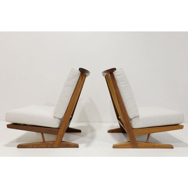 Experience timeless elegance with this beautiful pair of Conoid Lounge chairs by George Nakashima, crafted by the only...