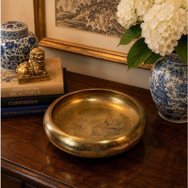 Beautiful vintage solid brass decorative bowl featuring an intricate engraved Asian landscape scene. The design depicts a...