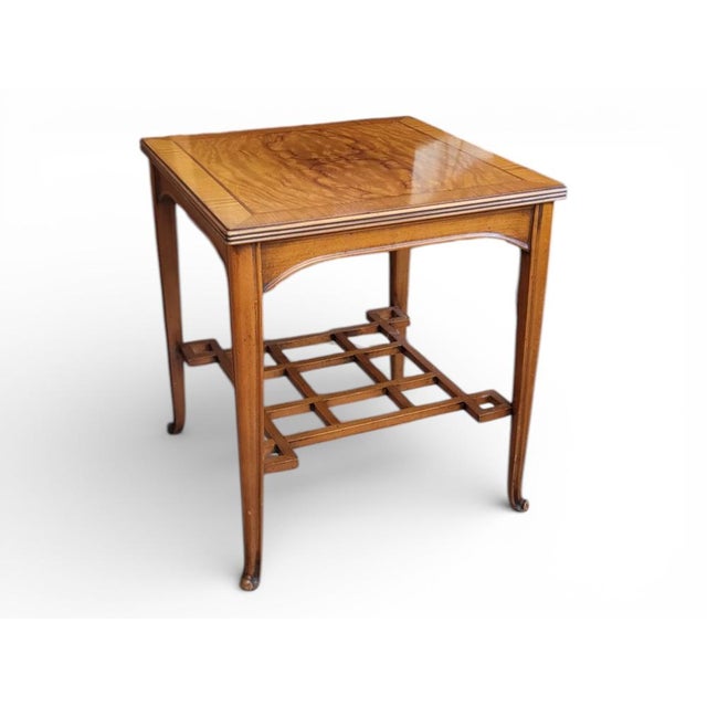 Art Nouveau coffee table that doubles as a magazine rack in a Japanese-inspired style. Oak table with walnut and maple...