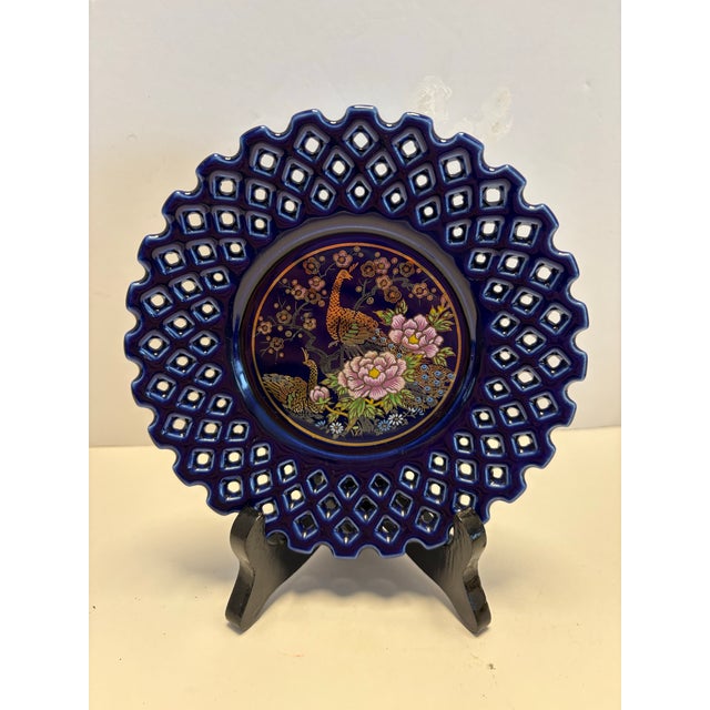 This elegant set of two vintage cobalt blue plates features a dramatic pierced openwork lattice rim and a richly detailed...