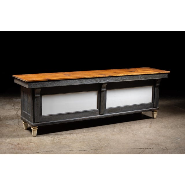 Substantial antique butcher's counter featuring a thick maple butcher block work surface set atop a dark-stained wooden...