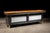 Substantial antique butcher's counter featuring a thick maple butcher block work surface set atop a dark-stained wooden...