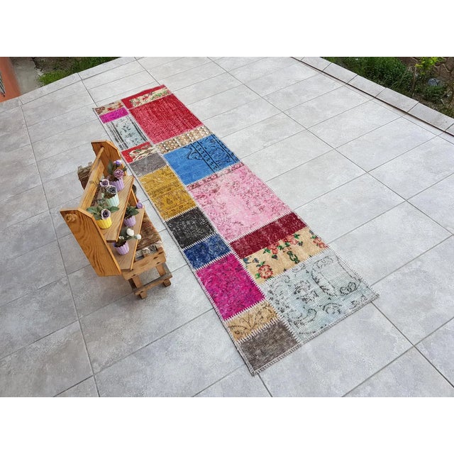 This is a vintage Turkish Oushak rug from the Mid 20th Century. The piece was hand-knotted.