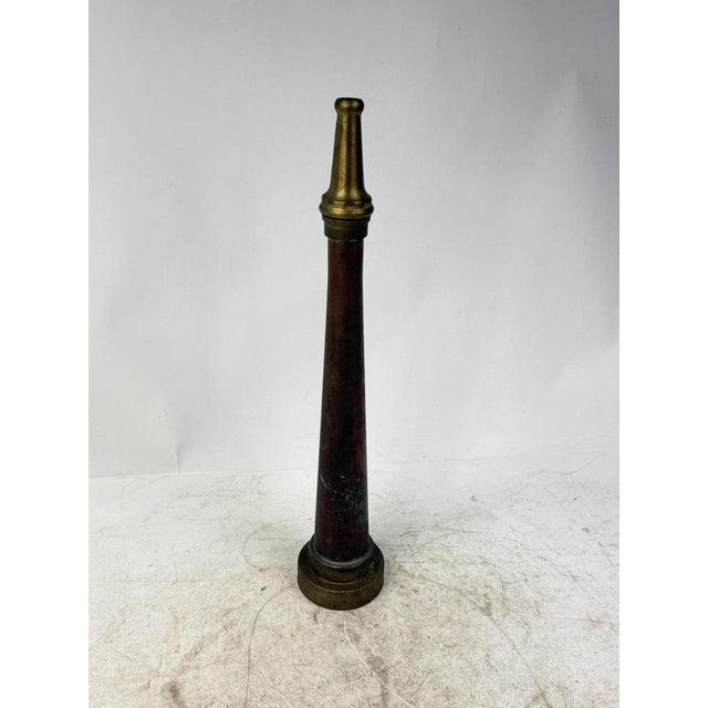 A fascinating historical relic of the fire department, featuring a conical copper structure with a brass nozzle.