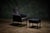 Montis black leather armchair with matching ottoman features a sleek metal frame and zipper details on the covers. -...