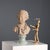 Terracotta sculpture depicting a young boy. This piece is attributed to the mentioned designer/maker. It has no...