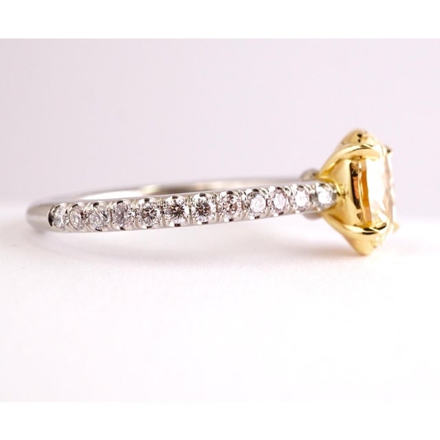 Fancy Yellow Diamond ring. Center stone: 1.12ct Oval cut Fancy Yellow SI1 diamond. Side stones: .32ct H-I-J VS1-SI1...