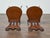 This pair of English mahogany hall chairs dates to the 19th century and stands out for its dramatic carved backrests...