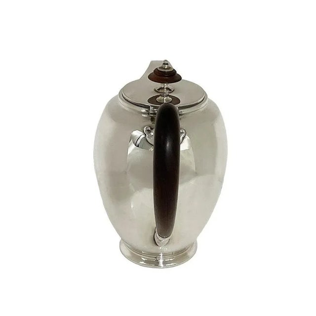 Sterling silver coffeepot, ca 1940 A beautiful silver coffeepot , which is in a beautiful round shape with walnut wooden...