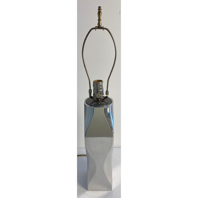 Striking vintage sculptural table lamp featuring a polished chrome body with a dramatic geometric, faceted form. The...