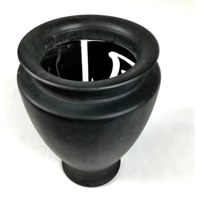 Very unusual vase to hold flowers or a votive candle. You choose. The glass is a mat finish with the calligraphy cut out...