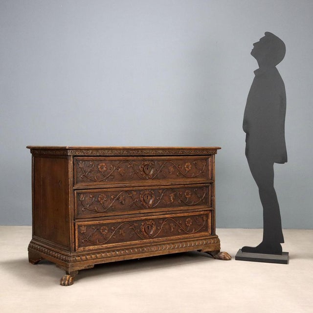 A typical chest of drawers from Feltre, made in the early 18th century, still in the Baroque style. The front features...