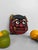 Dimensions: h 18 × w 18.5 × d 4.5 cm decorative japanese ceramic oni mask dating from around 1970, inspired by the demonic...