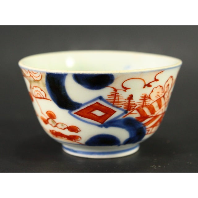 A great antique Japanese sake cup Stylishly decorated using IMARI style palette in underglaze blue, polychrome enamels and...