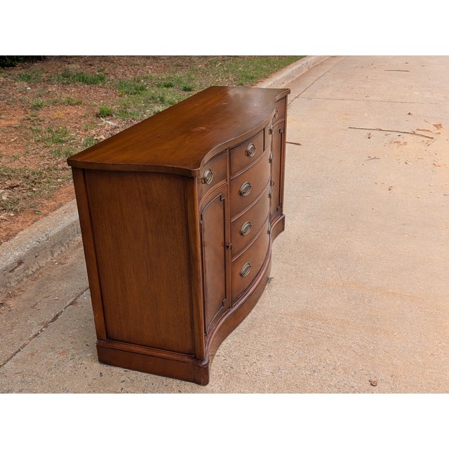 Introduce timeless elegance to your home with this stunning 1970s traditional style mahogany buffet. Perfectly balancing...