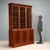 Mahogany bookcase from early 20th century England, featuring an elegant and functional design. The upper section has three...
