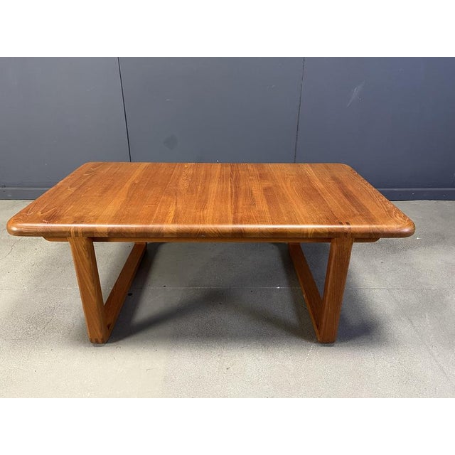 Mid century solid teak coffee table attributed to Niels Bach. Beautiful rectangular table top with an interlocking base....