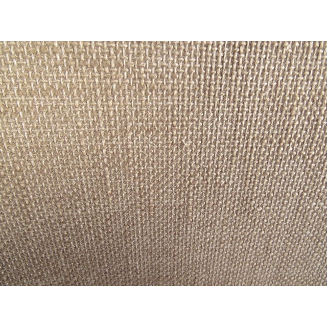 This vintage modern wingback lounge chair boasts an elegant high back design with slender tapered legs and plush...