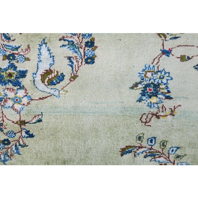 Fine impressive hand-knotted Kashan rug with an open design on a light pistachio colored background. Delicate colors,...