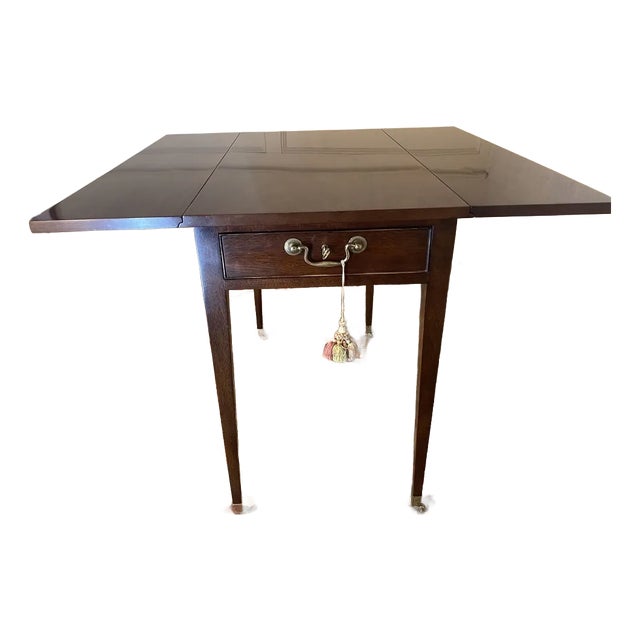 1990s The Kindel Drop-Leaf Mahogany Side Table Features a Drawer, Brass Caster Feet, and a Functioning Lock. With Two Leaves For Sale